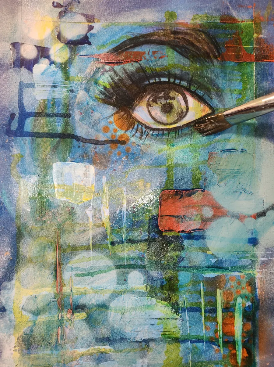 A paintbrush shaping the brow and lashes of a painted eye, mixed media